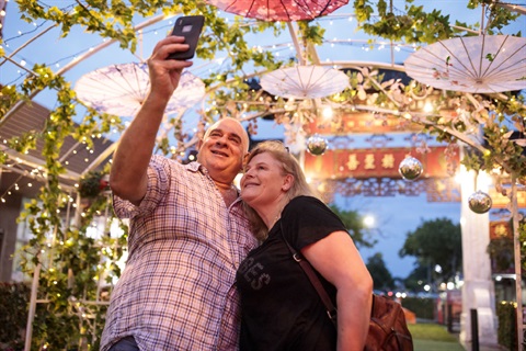 Couple taking selfie under archway in Freedom Plaza at Cabramatta's Sunset Parklet Event