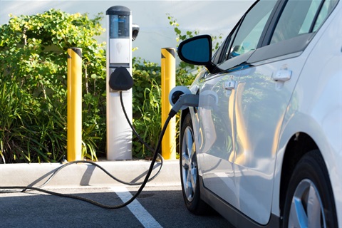 Electrical vehicle plugged into charging station