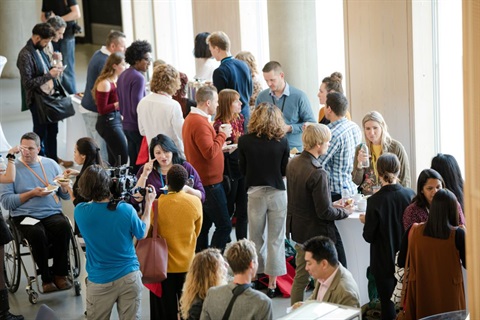 Isometric view of mingling crowd gathered at business event