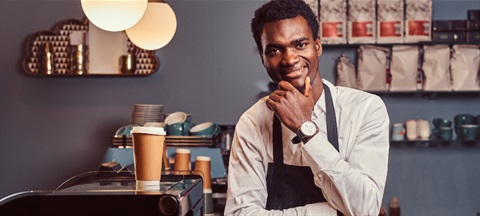 Hospitality barista smiling.