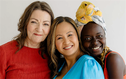 3 women posing with smiles.