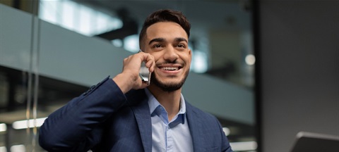 Multicultural corporate man on phone.